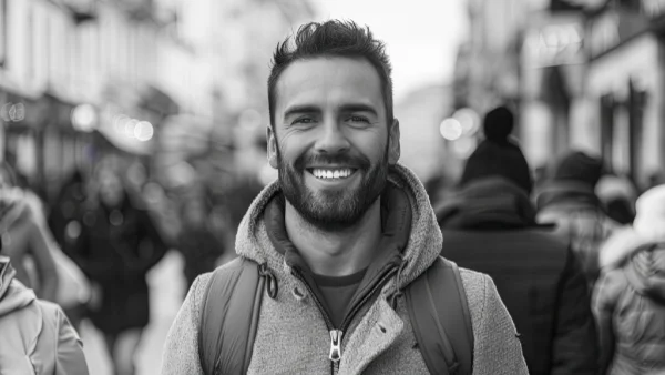 Happy smiling man walking down a busy street